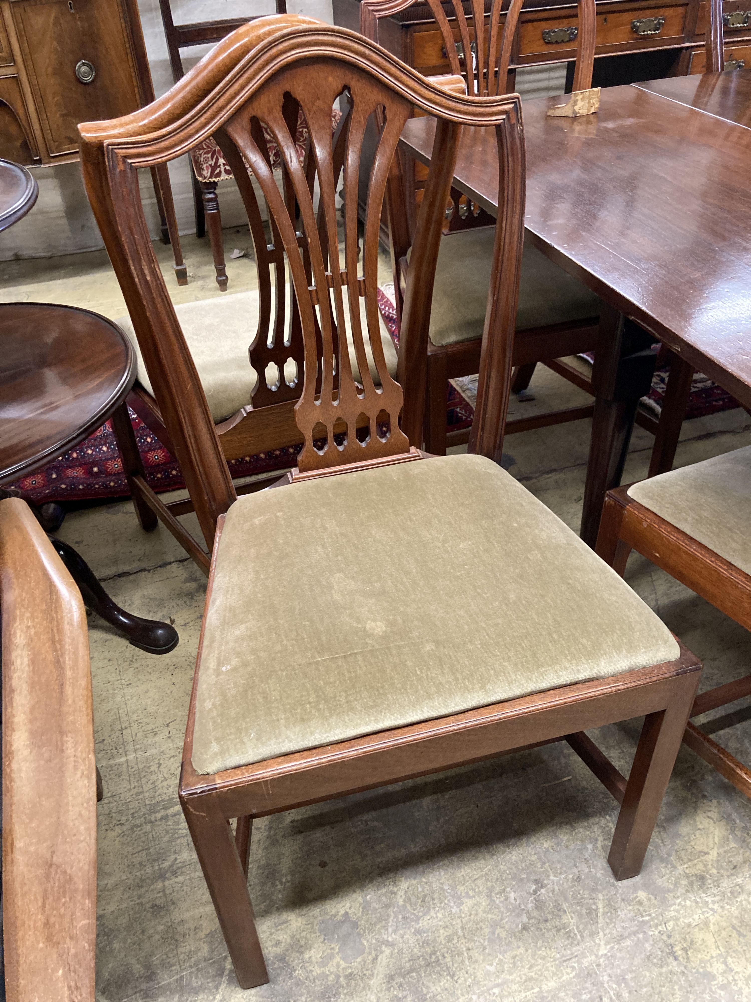 A set of eight Hepplewhite style mahogany pierced slat back dining chairs